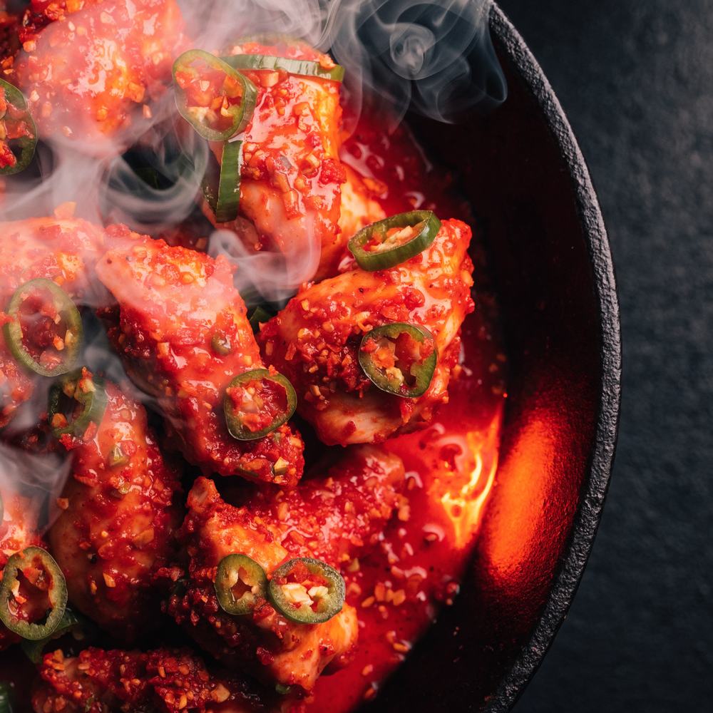 Bright red buldak fire chicken with green chilli