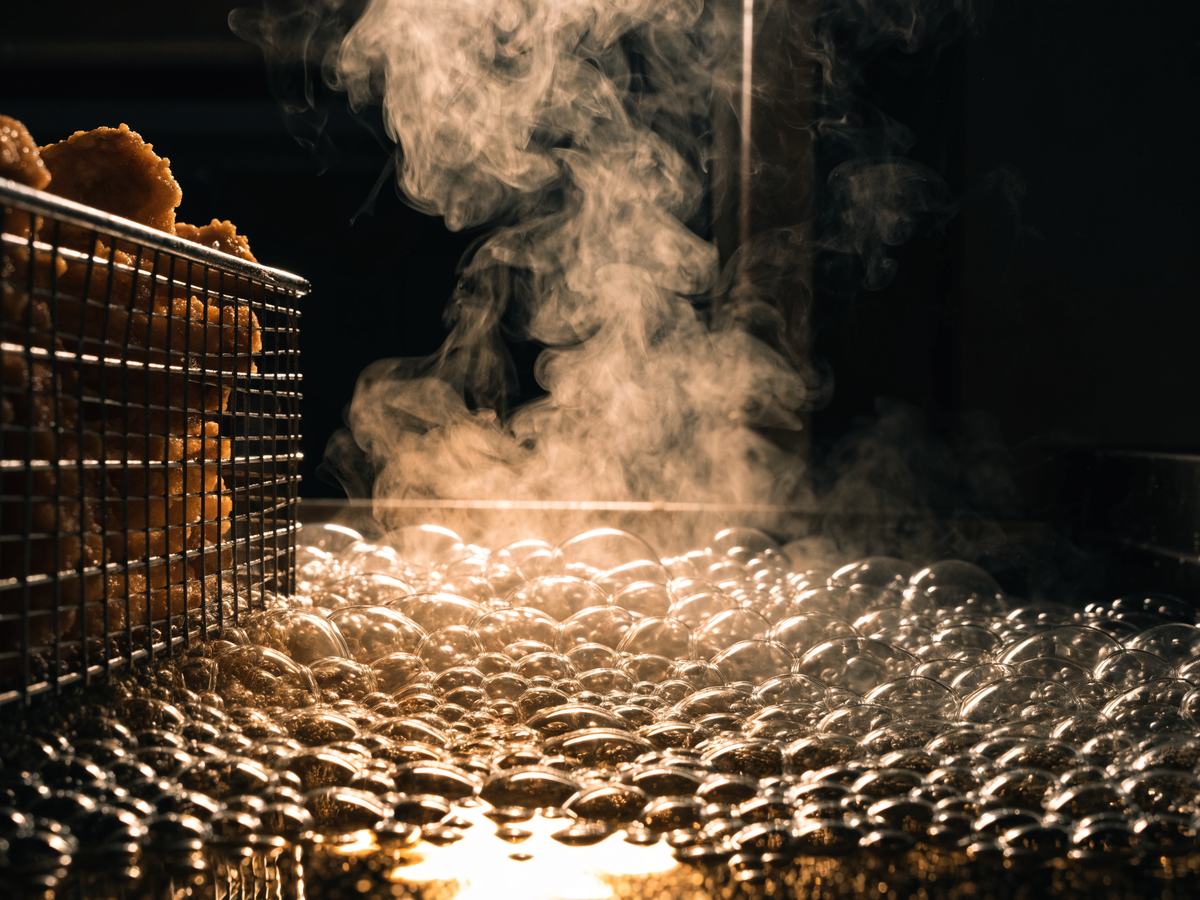 Chicken frying in bubbling oil