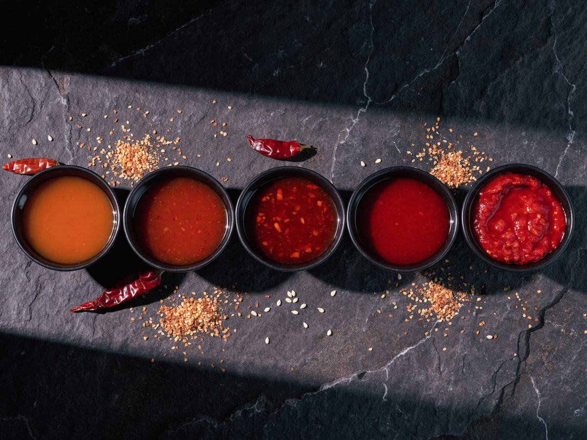 Five bowls of Korean chilli sauce, mild through to fiery