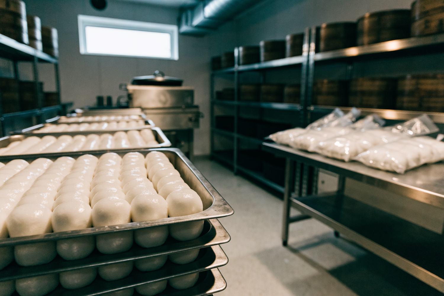 Trays and sealed bags of fresh rice cakes in the production kitchen